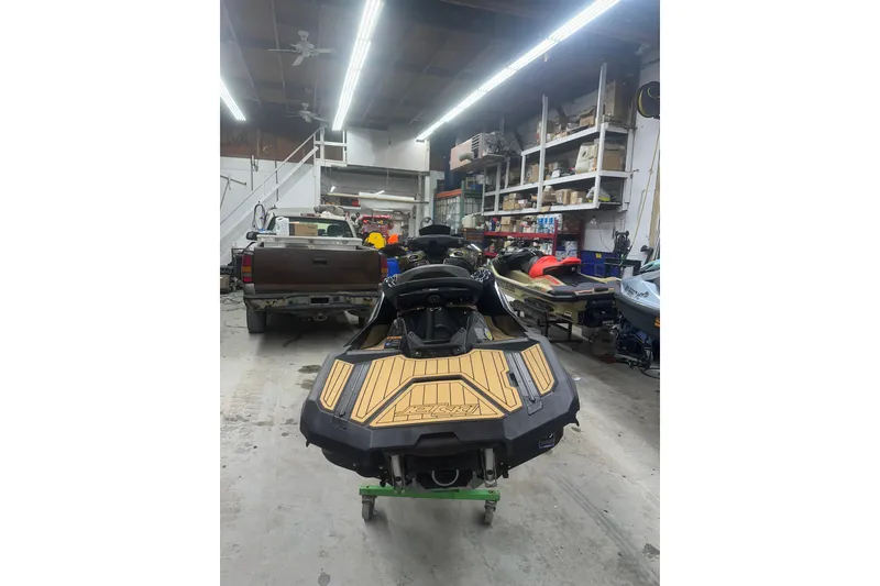 Slide: The Image of 2023 Kawasaki Jetski Ultra 310LX in a workshop setting. - 5