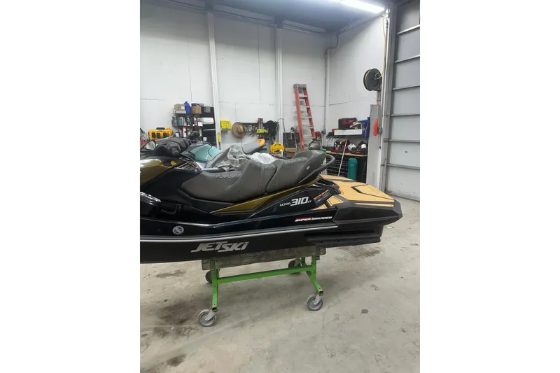 Slide: The Image of 2023 Kawasaki Jetski Ultra 310LX in a garage setting, showcasing sleek design. - 7