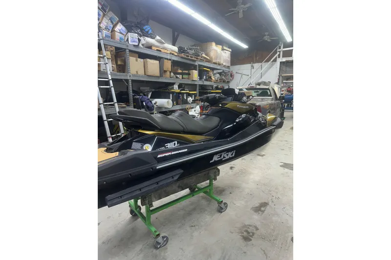 Slide: The Image of 2023 Kawasaki Jetski Ultra 310LX in a workshop setting. - 9