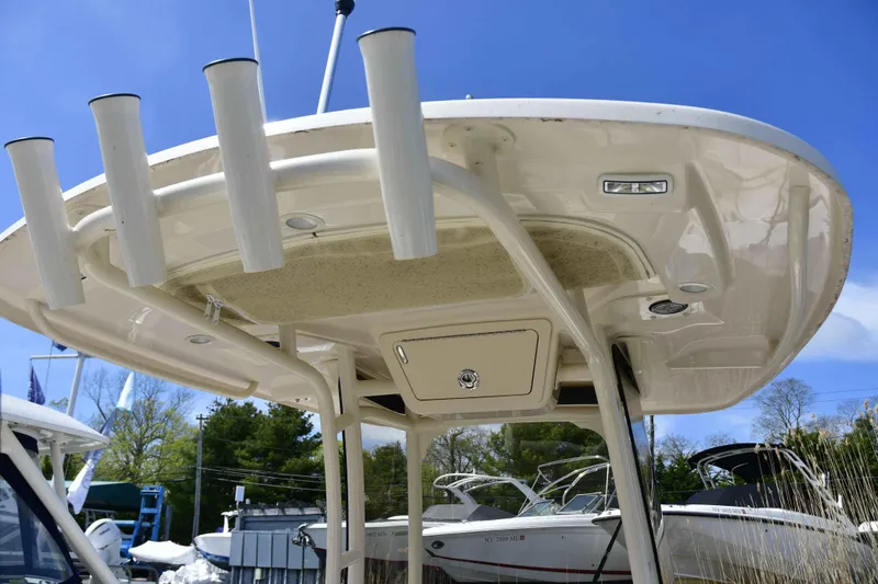 Slide: The Image of 2023 Grady-White Fisherman 257 boat with rod holders and T-top under clear sky. - 14