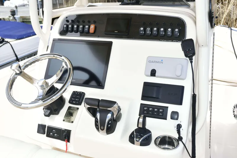 Slide: The Image of 2023 Grady-White Fisherman 257 boat dashboard with Garmin navigation and control panel. - 17