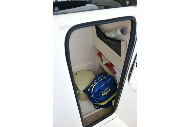 Slide: The Image of 2023 Grady-White Fisherman 257 storage area with life jacket and portable toilet. - 19