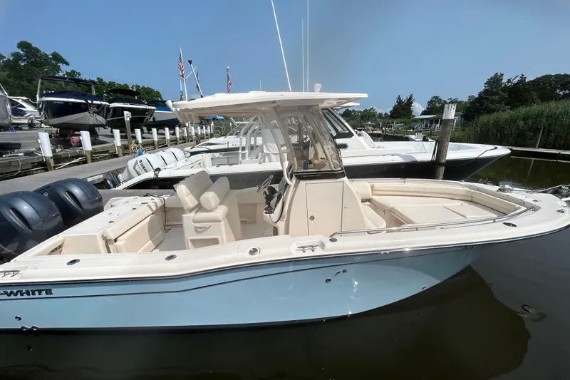 Slide: The Image of 2023 Grady-White Fisherman 257 boat docked at marina, featuring dual engines. - 2