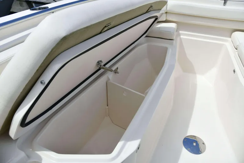 Slide: The Image of 2023 Grady-White Fisherman 257 boat storage compartment open, showcasing spacious interior. - 21