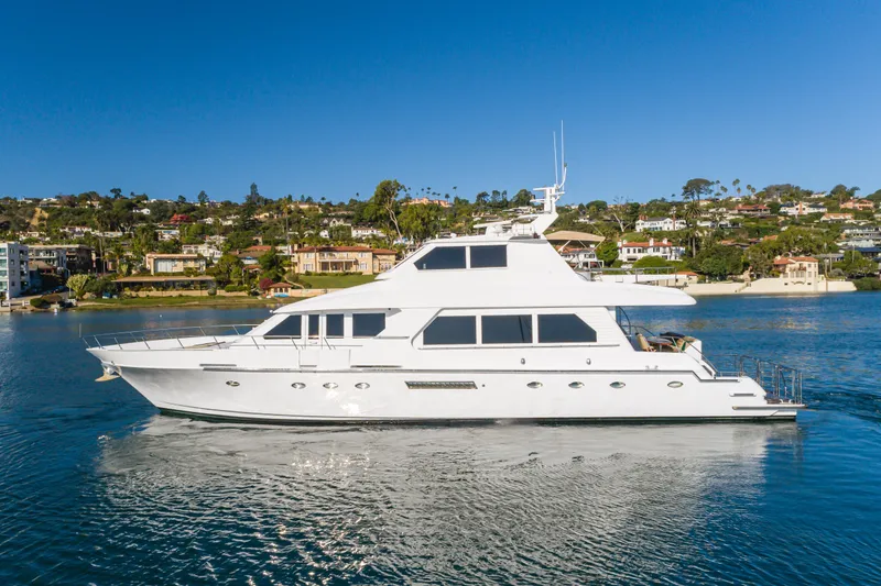 Slide: The Image of 1997 Forbes Cooper Pilothouse yacht cruising on a scenic waterfront. - 1