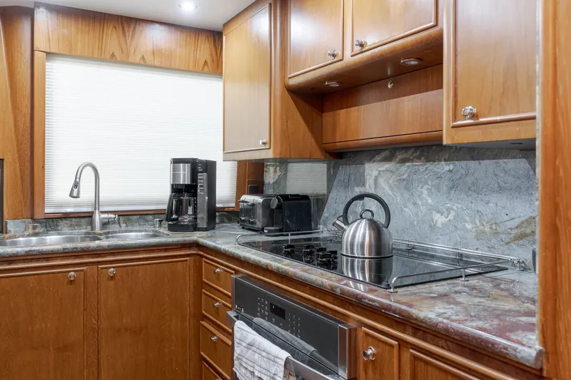 Slide: The Image of Luxurious 1997 Forbes Cooper Pilothouse kitchen with wood cabinets and modern appliances. - 15