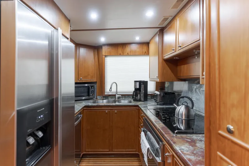 Slide: The Image of Luxurious 1997 Forbes Cooper Pilothouse kitchen with modern appliances and wooden cabinetry. - 16