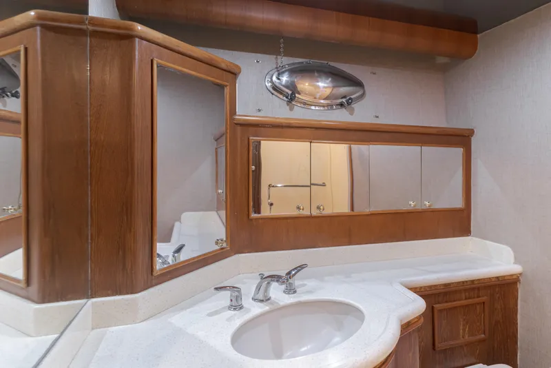 Slide: The Image of Luxurious bathroom in 1997 Forbes Cooper Pilothouse yacht with wooden cabinetry and modern fixtures. - 22