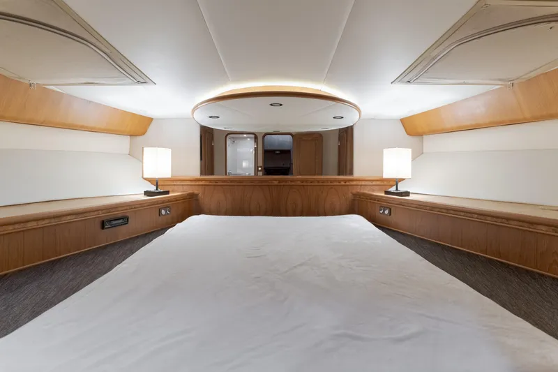 Slide: The Image of Luxurious 1997 Forbes Cooper Pilothouse yacht interior with elegant wood finish and ambient lighting. - 24