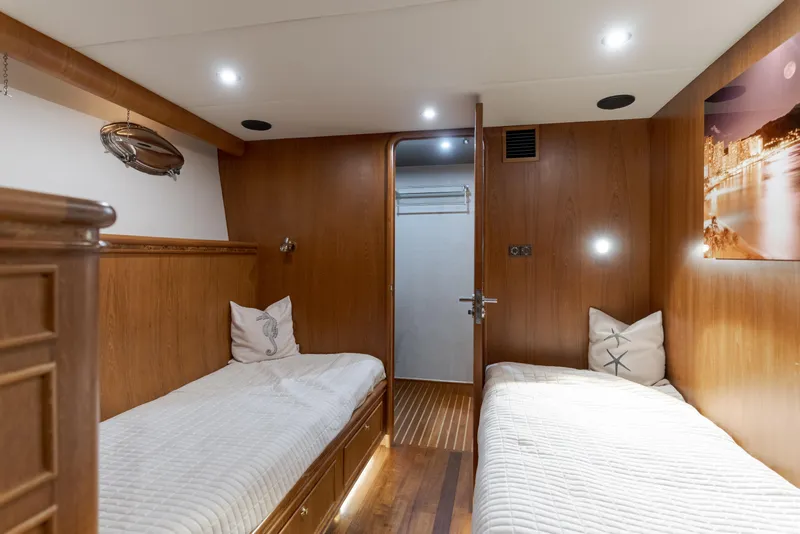 Slide: The Image of Luxurious 1997 Forbes Cooper Pilothouse cabin with twin beds and elegant wood paneling. - 26