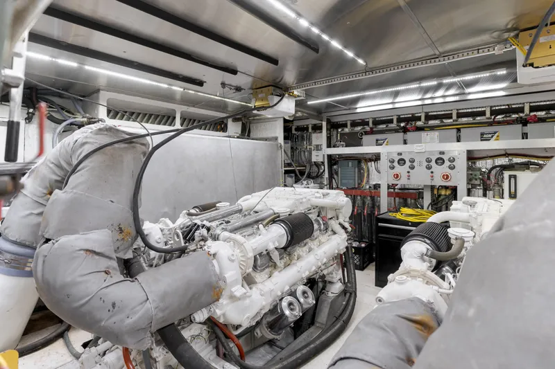 Slide: The Image of Engine room of a 1997 Forbes Cooper Pilothouse yacht, featuring complex machinery and control panels. - 30