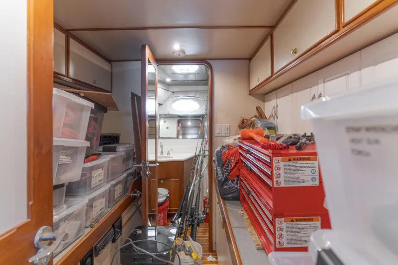 Slide: The Image of Interior of 1997 Forbes Cooper Pilothouse with storage, toolboxes, and fishing rods. - 33