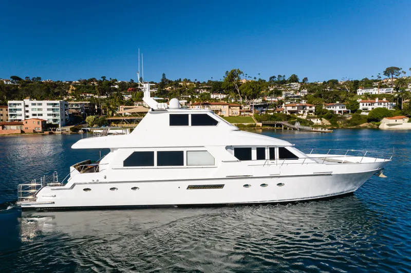 Slide: The Image of 1997 Forbes Cooper Pilothouse yacht cruising near scenic coastal homes. - 6