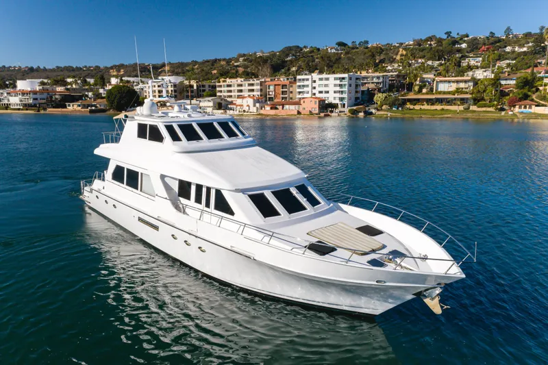 Slide: The Image of 1997 Forbes Cooper Pilothouse yacht cruising near coastal residential area. - 7