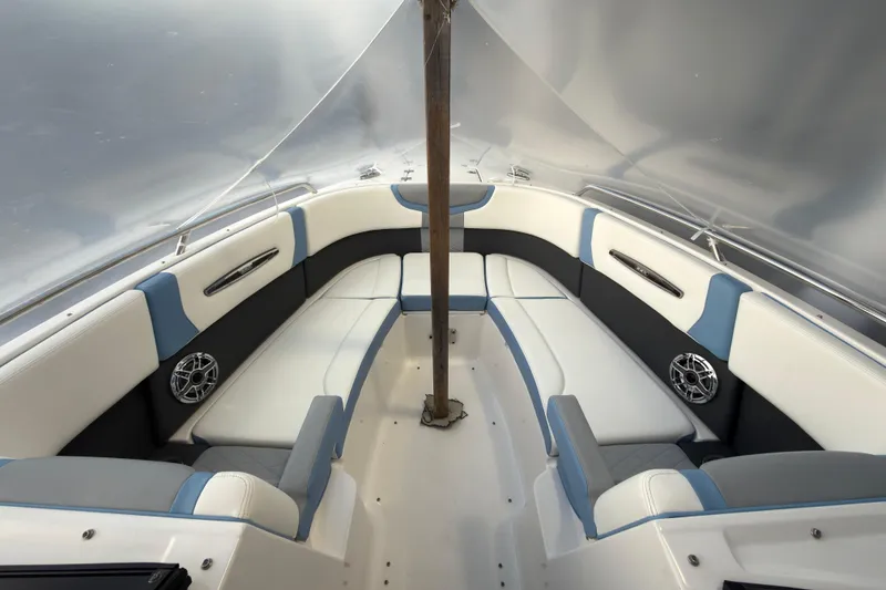 Slide: The Image of 2022 Chaparral 287 SSX boat interior with white and blue seating. - 11