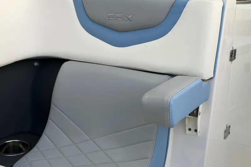 Slide: The Image of 2022 Chaparral 287 SSX boat seat with blue and gray upholstery, featuring SSX logo. - 16
