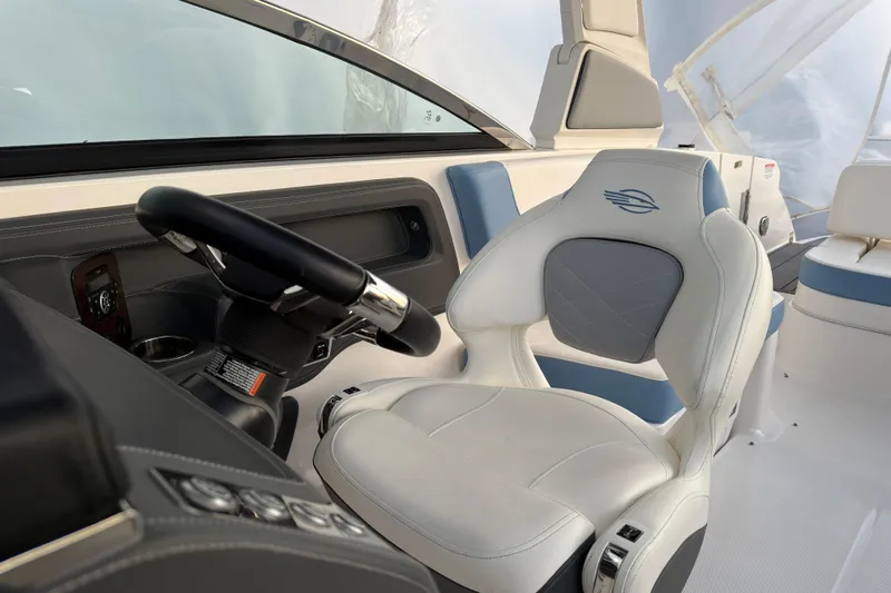 Slide: The Image of 2022 Chaparral 287 SSX boat interior with steering wheel and luxury seating. - 21