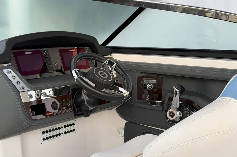 Slide: The Image of 2022 Chaparral 287 SSX boat dashboard with steering wheel and control panel. - 23