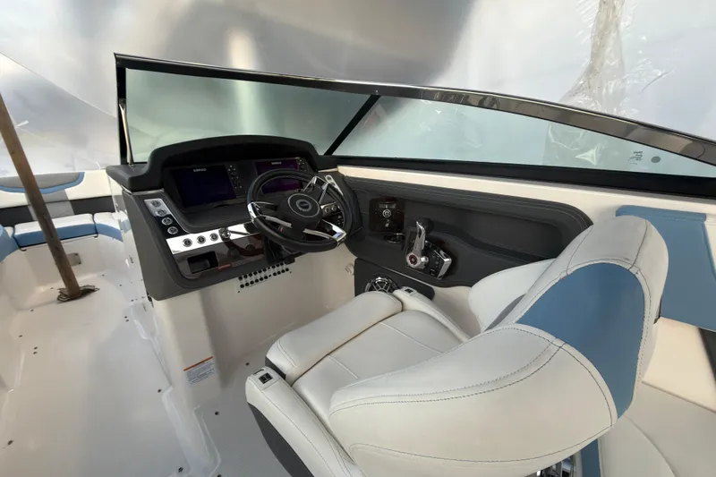 Slide: The Image of 2022 Chaparral 287 SSX boat cockpit with modern steering and controls. - 8