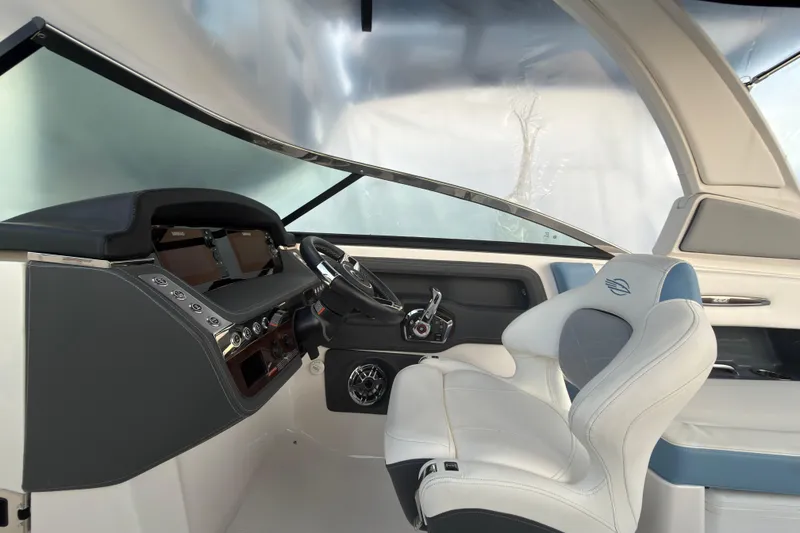 Slide: The Image of 2022 Chaparral 287 SSX boat cockpit with modern steering and luxurious seating. - 9