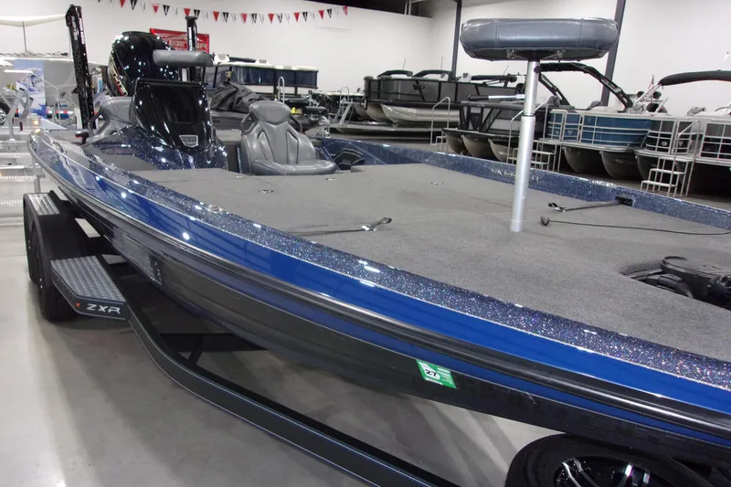 Slide: The Image of 2020 Skeeter ZXR21 bass boat with sleek blue design in showroom. - 10