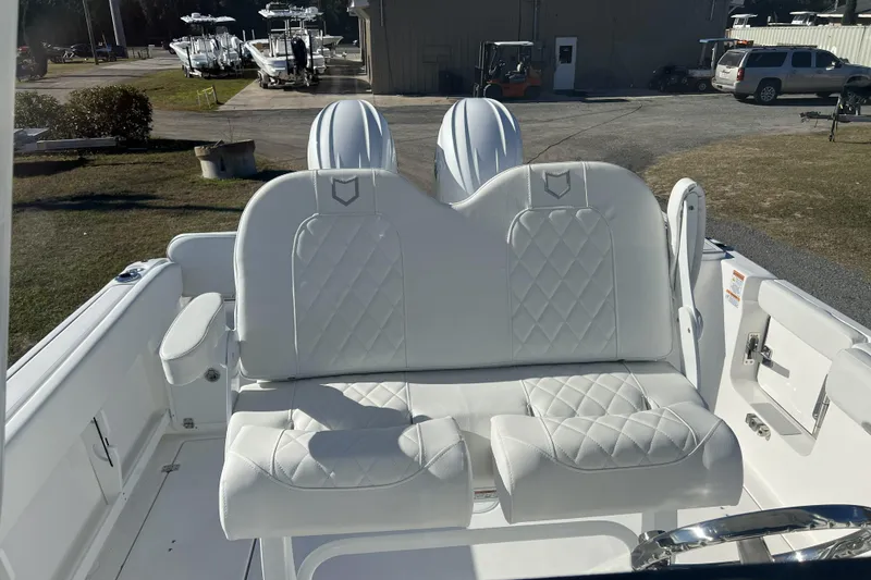 Slide: The Image of 2026 Sea Fox 268 Commander boat with white cushioned seating, docked outdoors. - 3