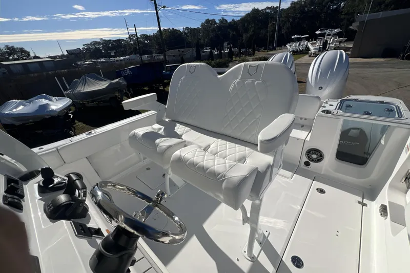 Slide: The Image of 2026 Sea Fox 268 Commander boat interior with white seating and steering wheel. - 5