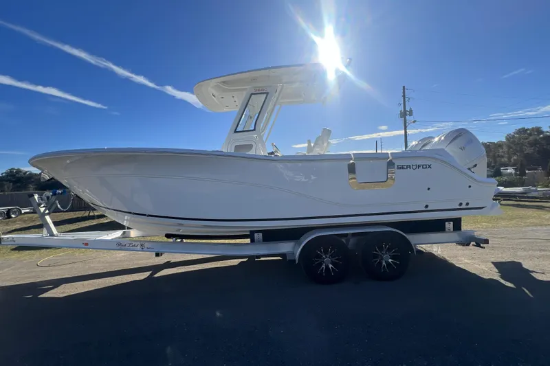 Slide: The Image of 2026 Sea Fox 268 Commander boat on trailer under bright sun. - 8