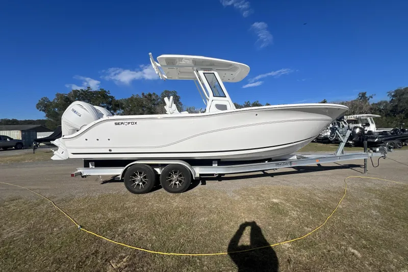 Slide: The Image of 2026 Sea Fox 268 Commander boat on trailer under clear blue sky. - 9