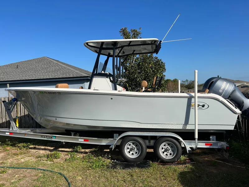 Slide: The Image of 2022 Sea Hunt Ultra 229 boat on trailer outdoors. - 1