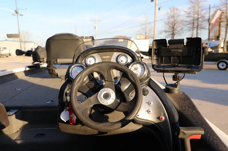 Slide: The Image of 2024 Bass Tracker PRO TEAM 190 boat dashboard with steering wheel and gauges. - 8