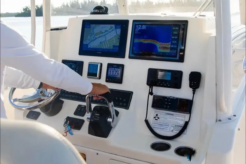 Slide: The Image of 2018 Cobia 320 Center Console dashboard with navigation and control systems. - 3
