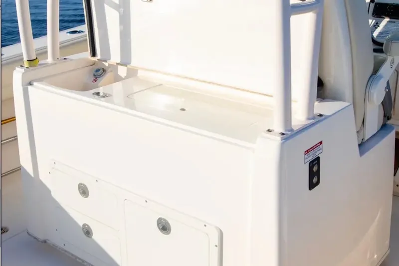 Slide: The Image of 2018 Cobia 320 Center Console boat interior with storage compartments. - 7