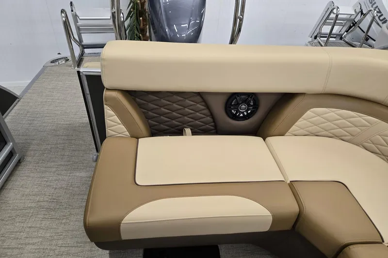 Slide: The Image of 2026 Godfrey Monaco 215 C boat interior with beige and brown seating, featuring a built-in speaker. - 14