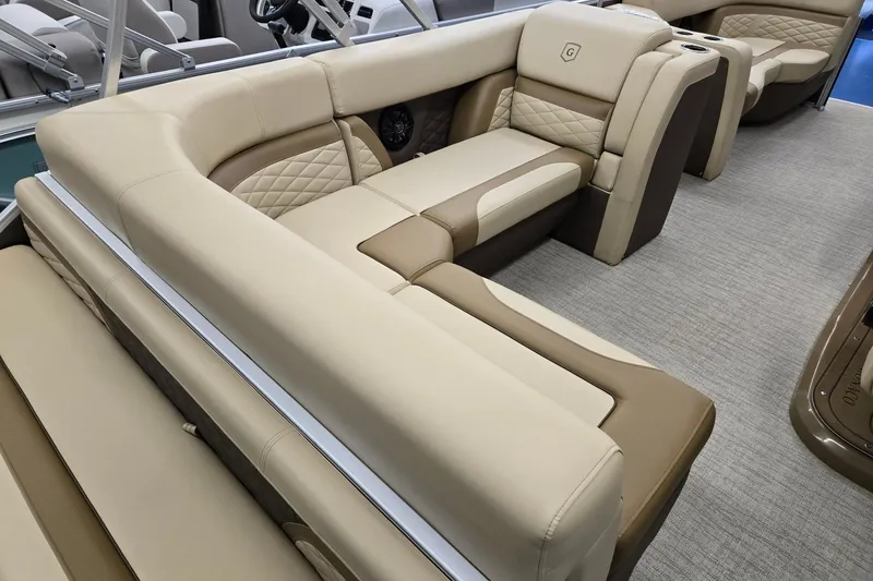 Slide: The Image of Luxurious seating on 2026 Godfrey Monaco 215 C pontoon boat, featuring beige and brown upholstery. - 21