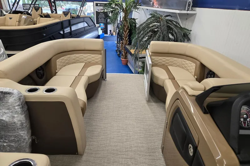 Slide: The Image of 2026 Godfrey Monaco 215 C pontoon boat interior with beige seating and modern design. - 22