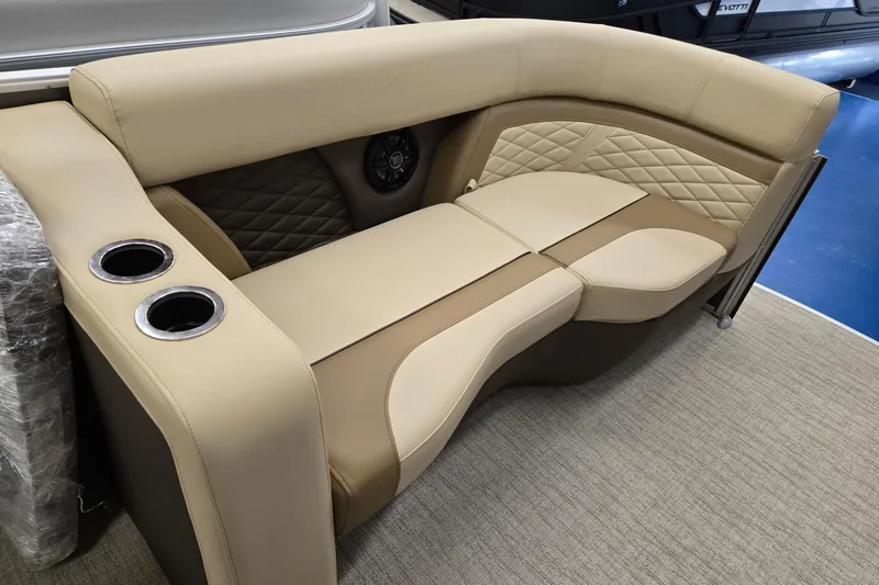 Slide: The Image of 2026 Godfrey Monaco 215 C boat seating with beige upholstery and cup holders. - 24