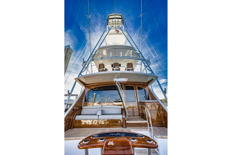 Slide: The Image of 2022 Viking 72 Convertible yacht, showcasing luxurious design and spacious deck under a clear blue sky. - 12