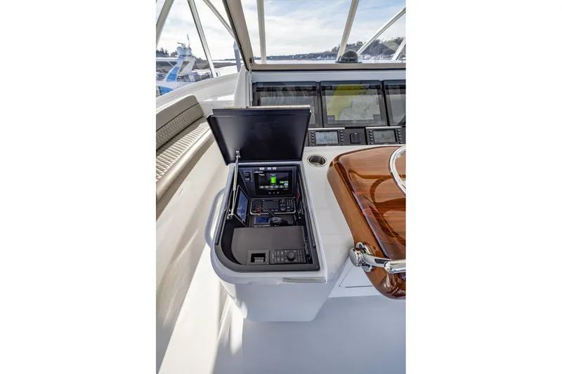 Slide: The Image of Control panel of 2022 Viking 72 Convertible yacht with navigation equipment. - 16
