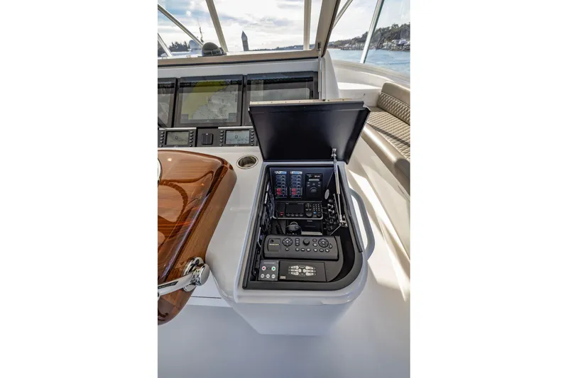 Slide: The Image of Control panel of 2022 Viking 72 Convertible yacht with navigation screens and controls. - 17