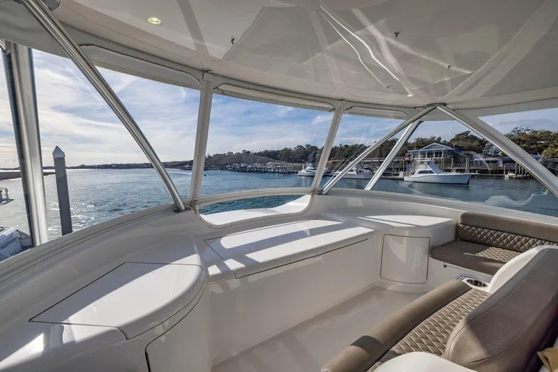 Slide: The Image of Interior view of 2022 Viking 72 Convertible yacht with waterfront scenery. - 23