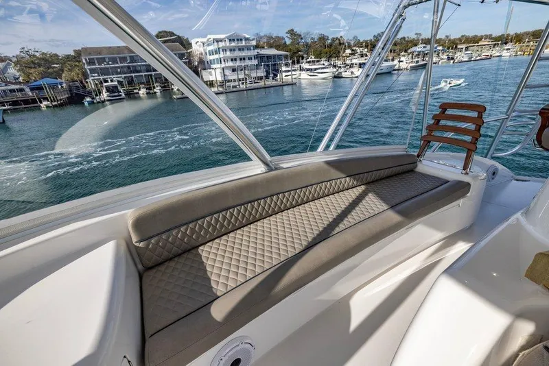 Slide: The Image of Luxurious seating on 2022 Viking 72 Convertible yacht with waterfront view. - 25