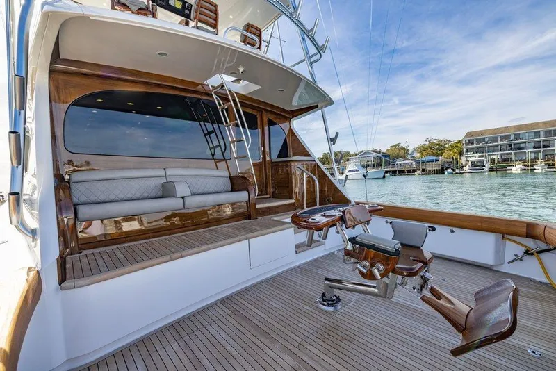 Slide: The Image of Luxurious 2022 Viking 72 Convertible yacht with elegant deck and seating area. - 28