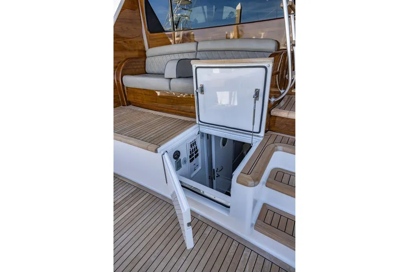 Slide: The Image of 2022 Viking 72 Convertible yacht with open hatch and teak deck. - 30