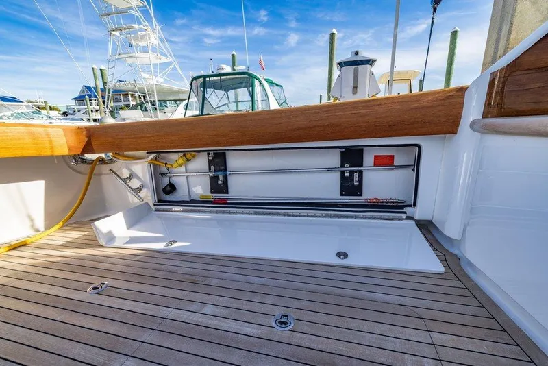 Slide: The Image of 2022 Viking 72 Convertible yacht deck with open storage compartment. - 32