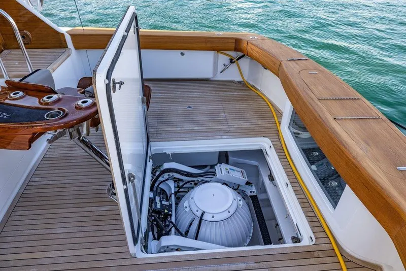 Slide: The Image of 2022 Viking 72 Convertible yacht with open hatch revealing engine compartment. - 35