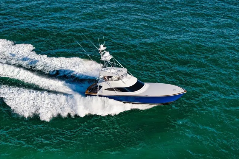 Slide: The Image of 2022 Viking 72 Convertible yacht cruising on open sea, creating white waves. - 4