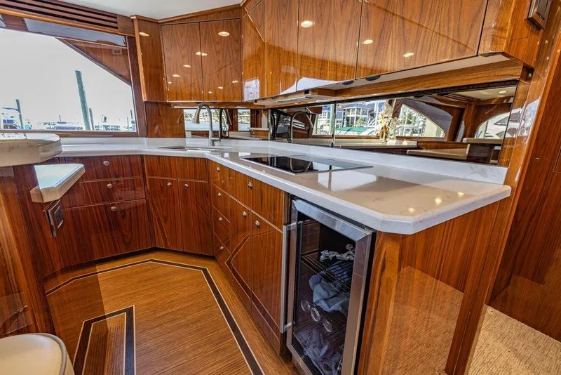 Slide: The Image of Luxurious kitchen interior of 2022 Viking 72 Convertible yacht with wood cabinetry and modern appliances. - 42