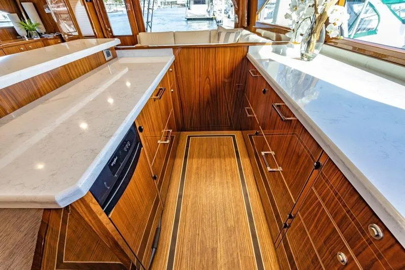 Slide: The Image of Luxurious interior of 2022 Viking 72 Convertible yacht with elegant wood cabinetry and countertops. - 43