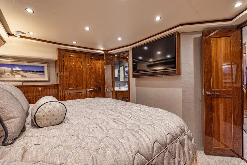Slide: The Image of Luxurious bedroom interior of 2022 Viking 72 Convertible yacht with elegant wood finishes. - 53